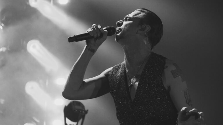 Editorial featured image for an article about darkwave, synthpop and new wave songs covered in metal, featuring Dave Gahan of Depeche Mode performing live