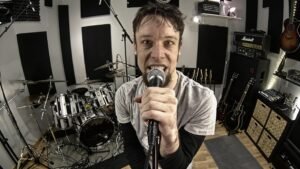 Leo Moracchioli singing into a microphone inside Frog Leap Studios