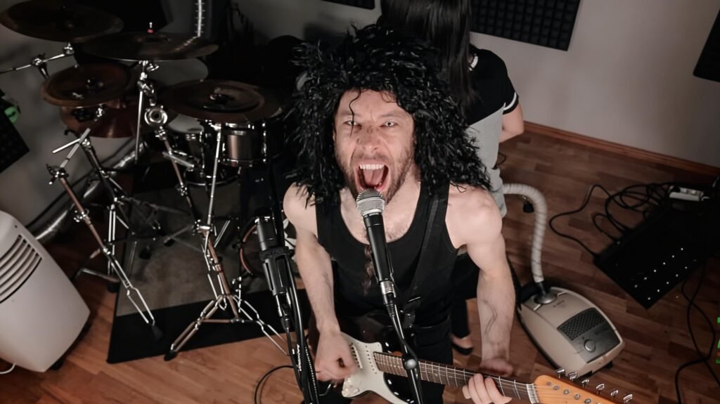 Leo Moracchioli singing and playing guitar in Frog Leap Studios during a high-energy performance
